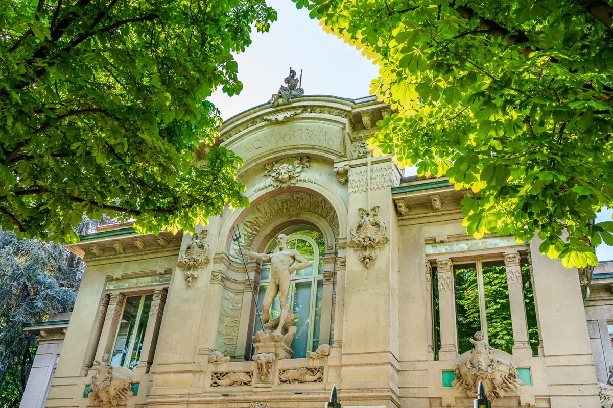 Milan, Lombardy, Italy: Facade of Civic Aquarium of Milan building in Sempione Park, with Neptune statue by Oreste Labo