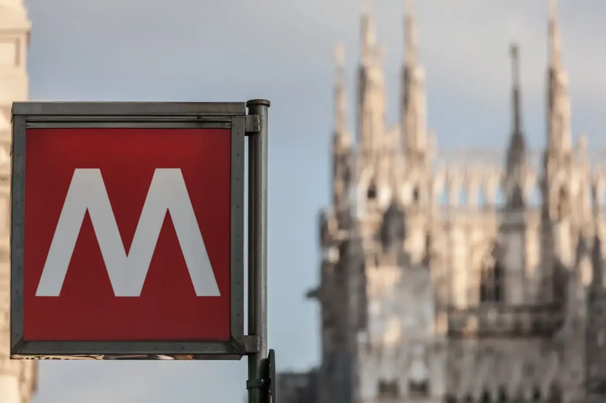 sign metro station in Milan Italy with blurred church on the background